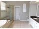 Spacious bathroom featuring a glass shower, soaking tub, and double vanity at 409 Lytton Cir, Orlando, FL 32824