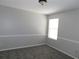 Neutral bedroom with chair rail, window, and carpeted floor at 409 Lytton Cir, Orlando, FL 32824