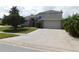 Charming two-story home featuring a spacious driveway and well-maintained landscaping at 409 Lytton Cir, Orlando, FL 32824