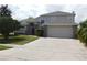 Charming two-story home featuring a spacious driveway and well-maintained landscaping at 409 Lytton Cir, Orlando, FL 32824