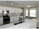 Modern kitchen features quartz countertops, stainless steel appliances, and ample cabinet space at 409 Lytton Cir, Orlando, FL 32824