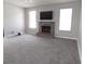 Bright living room with a cozy fireplace and neutral carpet at 409 Lytton Cir, Orlando, FL 32824