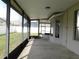Enclosed patio providing an airy feel, views of the fenced backyard, and concrete flooring at 409 Lytton Cir, Orlando, FL 32824