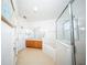 Bright bathroom featuring a soaking tub with glass shower, double sink vanity, and white tiled flooring at 466 Peppermill Cir, Kissimmee, FL 34758