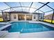 Sparkling screened-in pool surrounded by an expansive patio for relaxing and entertaining outdoors at 466 Peppermill Cir, Kissimmee, FL 34758