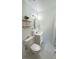 A clean bathroom contains a toilet, vanity and a decorative shelf at 4861 Haines Circle, Orlando, FL 32822