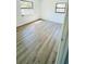 Bedroom featuring light wood flooring, two windows, and a neutral color palette at 4861 Haines Circle, Orlando, FL 32822