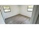 Freshly painted bedroom with two bright windows, showcasing modern flooring and a minimalist design at 4861 Haines Circle, Orlando, FL 32822