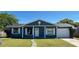 Charming single-story home features a blue exterior, white trim, and a well-maintained lawn at 4861 Haines Circle, Orlando, FL 32822