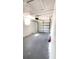 Spacious garage with concrete flooring, white walls, and functional door for easy vehicle storage at 4861 Haines Circle, Orlando, FL 32822