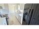 Bright kitchen featuring stainless steel appliances, white cabinets, and sleek countertops at 4861 Haines Circle, Orlando, FL 32822