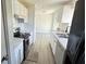Bright kitchen featuring stainless steel appliances, white cabinets, and sleek countertops at 4861 Haines Circle, Orlando, FL 32822