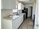 Well-lit kitchen with white cabinets, modern countertops, and stainless steel appliances at 4861 Haines Circle, Orlando, FL 32822