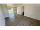 Bright living room with stylish gray wood flooring and sliding glass doors to the backyard at 4861 Haines Circle, Orlando, FL 32822