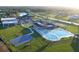 Aerial view of the community clubhouse, swimming pool, basketball court, and surrounding green space at 509 Lakeview Dr, Poinciana, FL 34759
