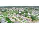 Aerial view of residential neighborhood with mature trees, homes with solar panels, and community streets at 509 Lakeview Dr, Poinciana, FL 34759
