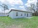 Spacious backyard featuring lush lawn, patio, and rear home view at 509 Lakeview Dr, Poinciana, FL 34759