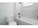 Bright bathroom featuring tub with stylish tiled wall and modern fixtures at 509 Lakeview Dr, Poinciana, FL 34759