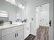 Bathroom boasts double vanity with quartz counters and dark brown vinyl floors at 509 Lakeview Dr, Poinciana, FL 34759
