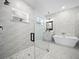 Modern bathroom featuring a glass shower, soaking tub, stylish tile work, and double vanities at 509 Lakeview Dr, Poinciana, FL 34759