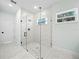 Bright bathroom features walk in shower and stylish hexagonal tiles at 509 Lakeview Dr, Poinciana, FL 34759