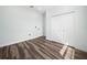 Simple bedroom with light walls, wood flooring, and closet at 509 Lakeview Dr, Poinciana, FL 34759
