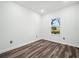 Bright, vacant bedroom with hardwood floors and a sunlit window at 509 Lakeview Dr, Poinciana, FL 34759