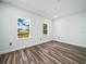 Bright bedroom with two windows, offering natural light and a view of the outdoors at 509 Lakeview Dr, Poinciana, FL 34759