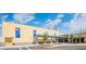 Community building with colorful signage, flags, covered entrance, and accessible parking at 509 Lakeview Dr, Poinciana, FL 34759
