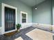 Inviting front porch featuring brick pavers, a black front door, and a decorative hanging light fixture at 509 Lakeview Dr, Poinciana, FL 34759