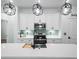 Elegant kitchen island with a modern faucet, pendant lighting, and stylish backsplash at 509 Lakeview Dr, Poinciana, FL 34759