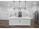 Bright kitchen with a large center island, stainless steel appliances, and modern pendant lighting at 509 Lakeview Dr, Poinciana, FL 34759