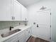 Laundry room featuring white cabinetry, countertop space, and modern fixtures at 509 Lakeview Dr, Poinciana, FL 34759