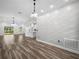 Bright and airy living room with laminate flooring, white accent wall, and modern lighting fixtures at 509 Lakeview Dr, Poinciana, FL 34759
