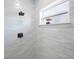 Modern shower with gray tile, window, and sleek fixtures at 509 Lakeview Dr, Poinciana, FL 34759