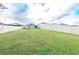 Expansive backyard with well-maintained lawn and white fencing surrounding the property at 551 Meadow Bend Dr, Davenport, FL 33837