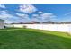 Well-maintained backyard with healthy green grass and a white vinyl fence at 579 Lucerne Blvd, Winter Haven, FL 33881