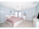 Bright bedroom features modern ceiling fan, tile floors, and light blue walls at 579 Lucerne Blvd, Winter Haven, FL 33881