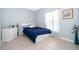 Clean bedroom with tile flooring and blue accents creates a peaceful retreat with ample sunlight at 579 Lucerne Blvd, Winter Haven, FL 33881