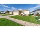 Well-maintained lawn and exterior of single-story home with a two-car garage in a residential neighborhood at 579 Lucerne Blvd, Winter Haven, FL 33881