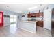 This bright kitchen features an island with sink, stainless appliances, and sliding doors to the yard at 579 Lucerne Blvd, Winter Haven, FL 33881