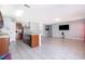 Open-concept kitchen with island sink, stainless steel appliances, and tile floors connects to living area at 579 Lucerne Blvd, Winter Haven, FL 33881