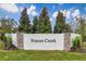 Forest Creek community sign with stone accents and lush landscaping, welcomes residents and guests alike at 812 Blue Creek Dr, Haines City, FL 33844
