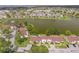 Aerial view highlighting the building's location near a lake and surrounding area at 86 Pine Island Cir, Kissimmee, FL 34743