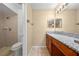 Well-lit bathroom featuring a granite vanity top and tiled shower stall at 86 Pine Island Cir, Kissimmee, FL 34743