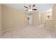Bedroom with tile floors and ceiling fan provides access to the ensuite bathroom and walk-in closet at 86 Pine Island Cir, Kissimmee, FL 34743