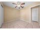Bedroom with tile flooring, a ceiling fan, and closet with sliding doors providing ample storage at 86 Pine Island Cir, Kissimmee, FL 34743