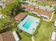 Aerial view of a community pool with lounge chairs, seating areas, and lush landscaping at 86 Pine Island Cir, Kissimmee, FL 34743