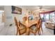 Elegant dining area with decorative wood table and chairs situated near a living area and an exterior view at 86 Pine Island Cir, Kissimmee, FL 34743