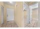 Bright entryway featuring tile floors, neutral walls, and doorways to the bathroom and another room at 86 Pine Island Cir, Kissimmee, FL 34743